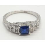 An Art-deco style ladies 18ct white gold diamond and sapphire (emerald cut) ring. Szie N. 0.3ct