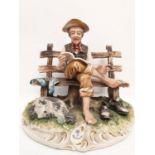 A Capodimonte figure of an old man drying his socks. 22cm height x 28cm diameter.