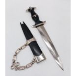 An interesting reproduction Nazi dagger with chain attached to its scabbard. German inscription on