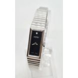 Vintage ladies Roamer wristwatch. Square black face with white hands having silver chrome strap.