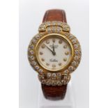 Vintage 18ct gold Rolex Geneve Cellini ladies watch with round face and diamond encrusted bezel
