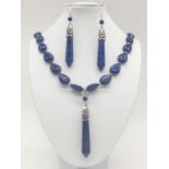 A tear drop shaped lapis lazuli necklace and earrings with long obelisks. Necklace length: 54cm,