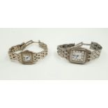 A pair of Cartier styled ladies wristwatches. Stainless steel bracelets.