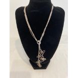 Silver fine strand necklace, each strand having a butterfly pendant. Pull through style to front