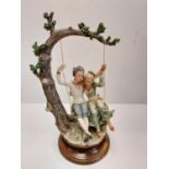 A Giuseppe Armani Capodimonte, 'Lovers on a Swing' figurine. 45cm in height.