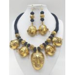 An original west African (Benin style) necklace and earrings set with gilded metal tribal masks.