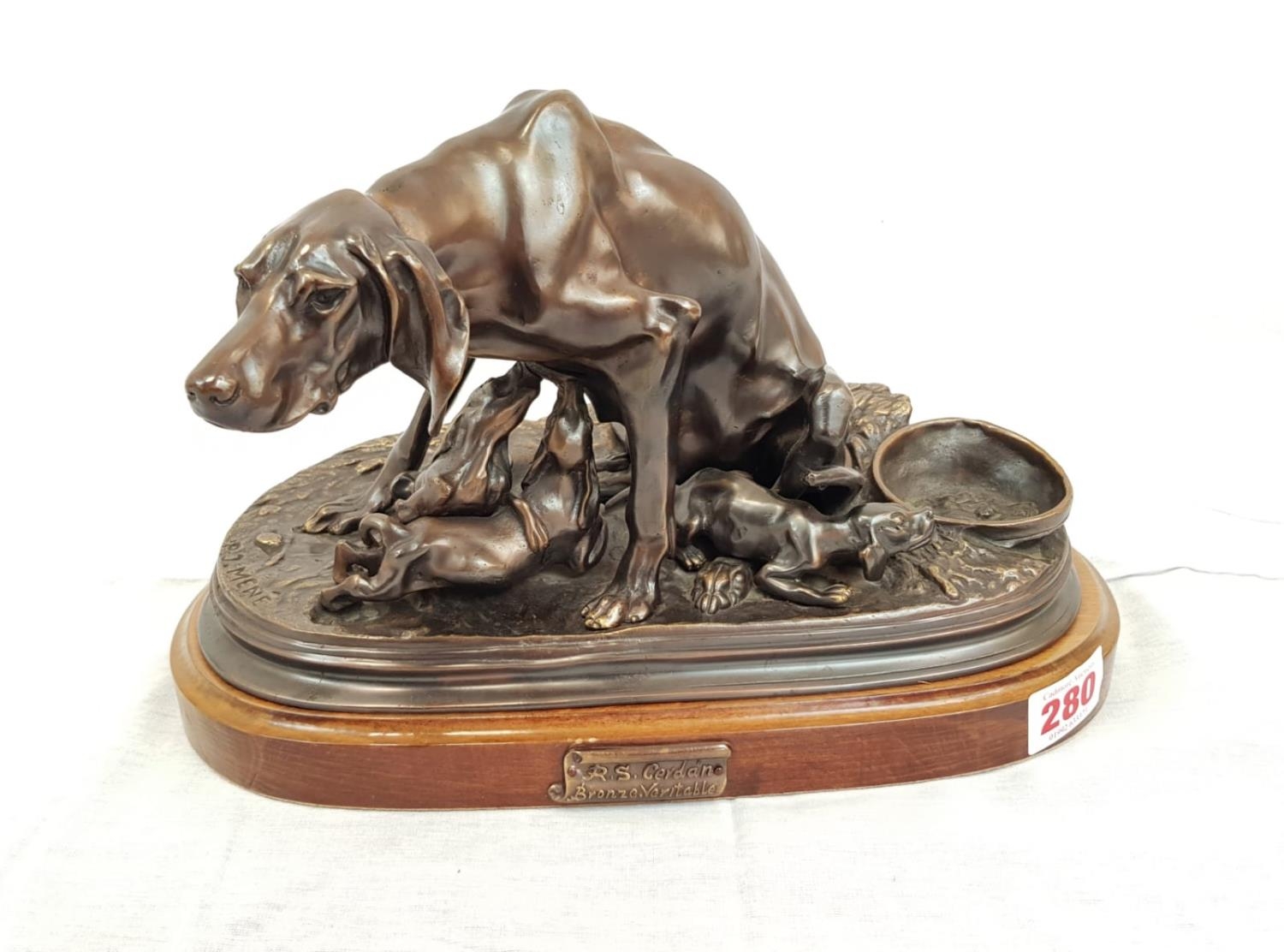 A stunning bronze veritable sculpture of a dog feeding its pups. Made by the sculptor R.S Gerdon.