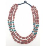 An early 70s Indian, Hippy style, three rows of red coral and turquoise necklace, originally