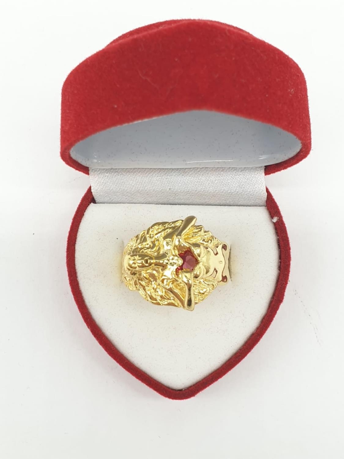 An unusual silver (stamped 925) and gold filled ring depicting a lady offering her heart. Ring size: