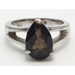 Silver Ring, with brown topaz pear shaped stone in silver claw mount. Pierced shoulders and clear