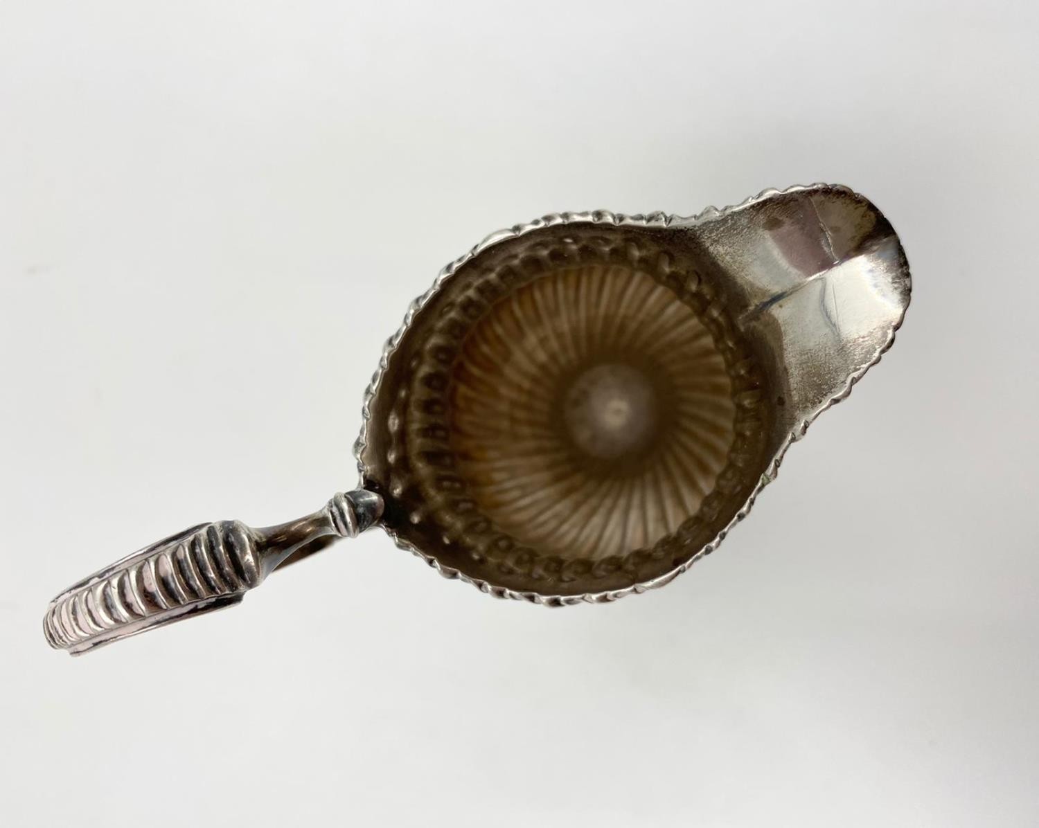 A finely detailed silver creamer in ribbed swirl pattern with curved handle on a pedestal base. 14cm - Image 3 of 4