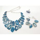 A necklace, bracelet and ring set with blue agate from Botswana, in a presentation case. Necklace