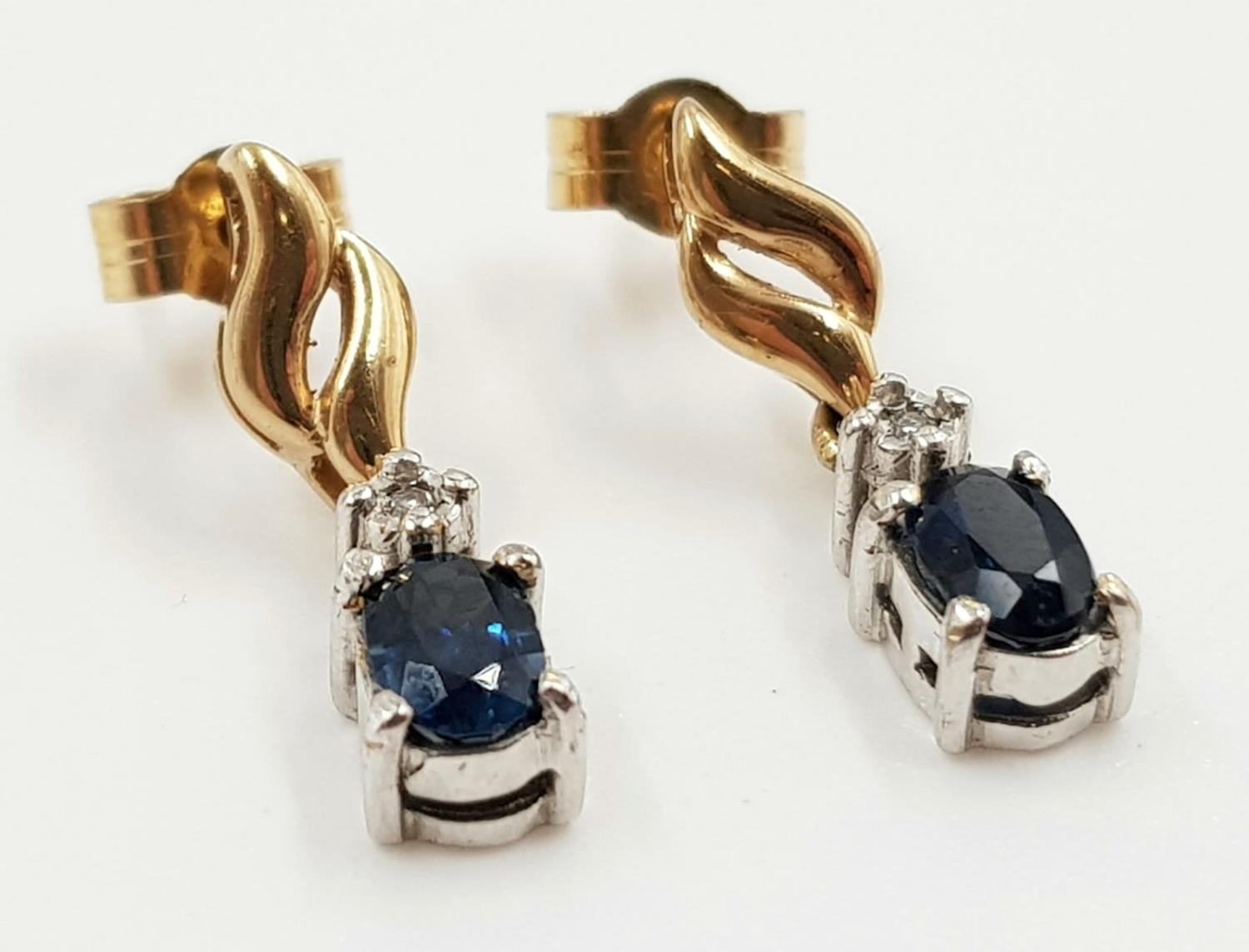 A pair of sapphire and diamond earrings in 9ct gold. 2.4g total weight.