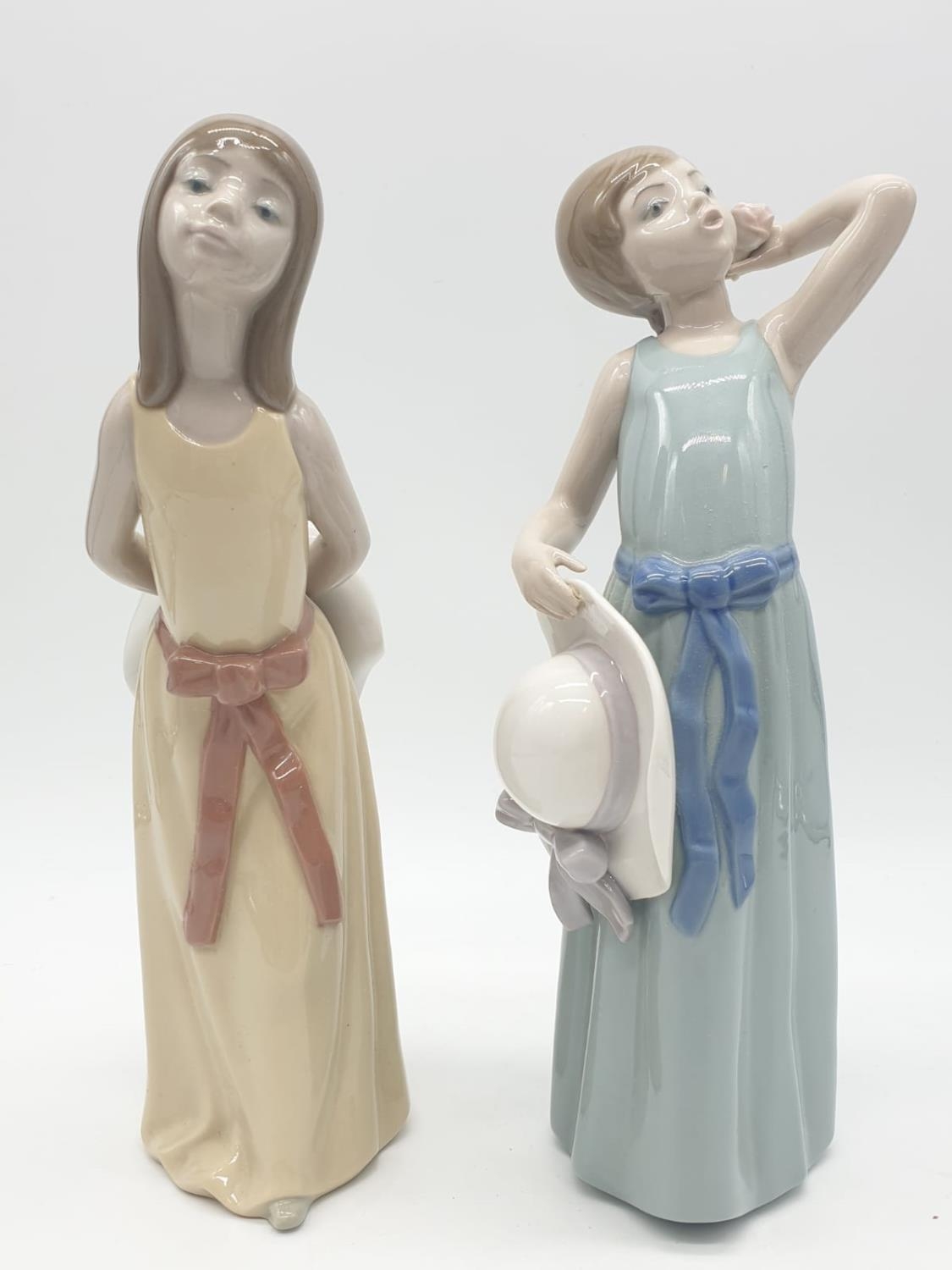 Lladro pair of youthful young girls. 26cm tall.