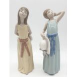 Lladro pair of youthful young girls. 26cm tall.