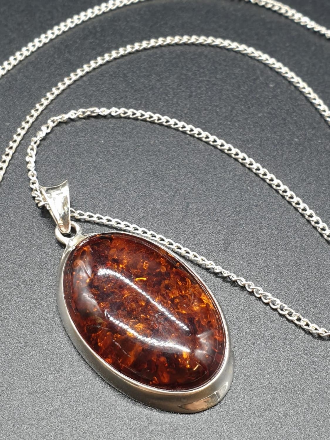 A large Amber Pendant Set in Silver on a 50cm Silver Chain 9.5g