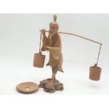 Hand carved wooden figure a Chinese pedlar. 20cm tall.