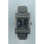 Gucci stainless steel watch tank style with black face and diamond bezel and shoulders