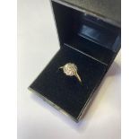 18ct gold ring having platinum flower type top with diamond points. Full Birmingham UK hallmark.