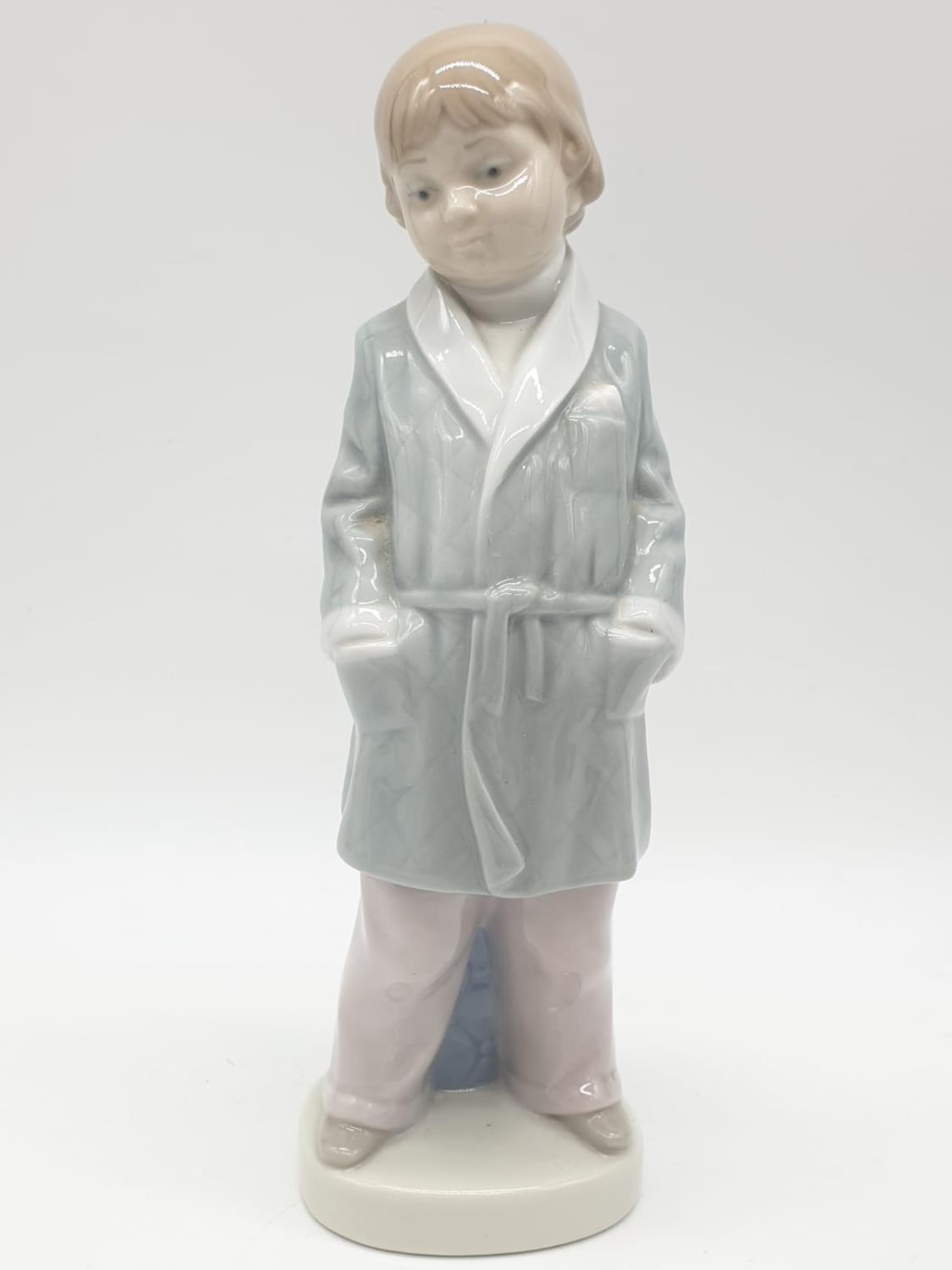 Lladro boy in dressing gown. 21cm tall.