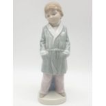 Lladro boy in dressing gown. 21cm tall.