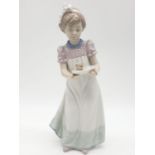 Lladro girl holding a cake on a plate. 20cm tall.