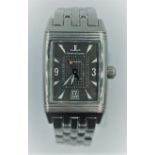 Jaeger-lecoultre Reverso watch with rectangular black face and steel strap.