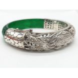 A beautiful Chinese hand carved jade and sterling silver bracelet with engraved dragons. Internal