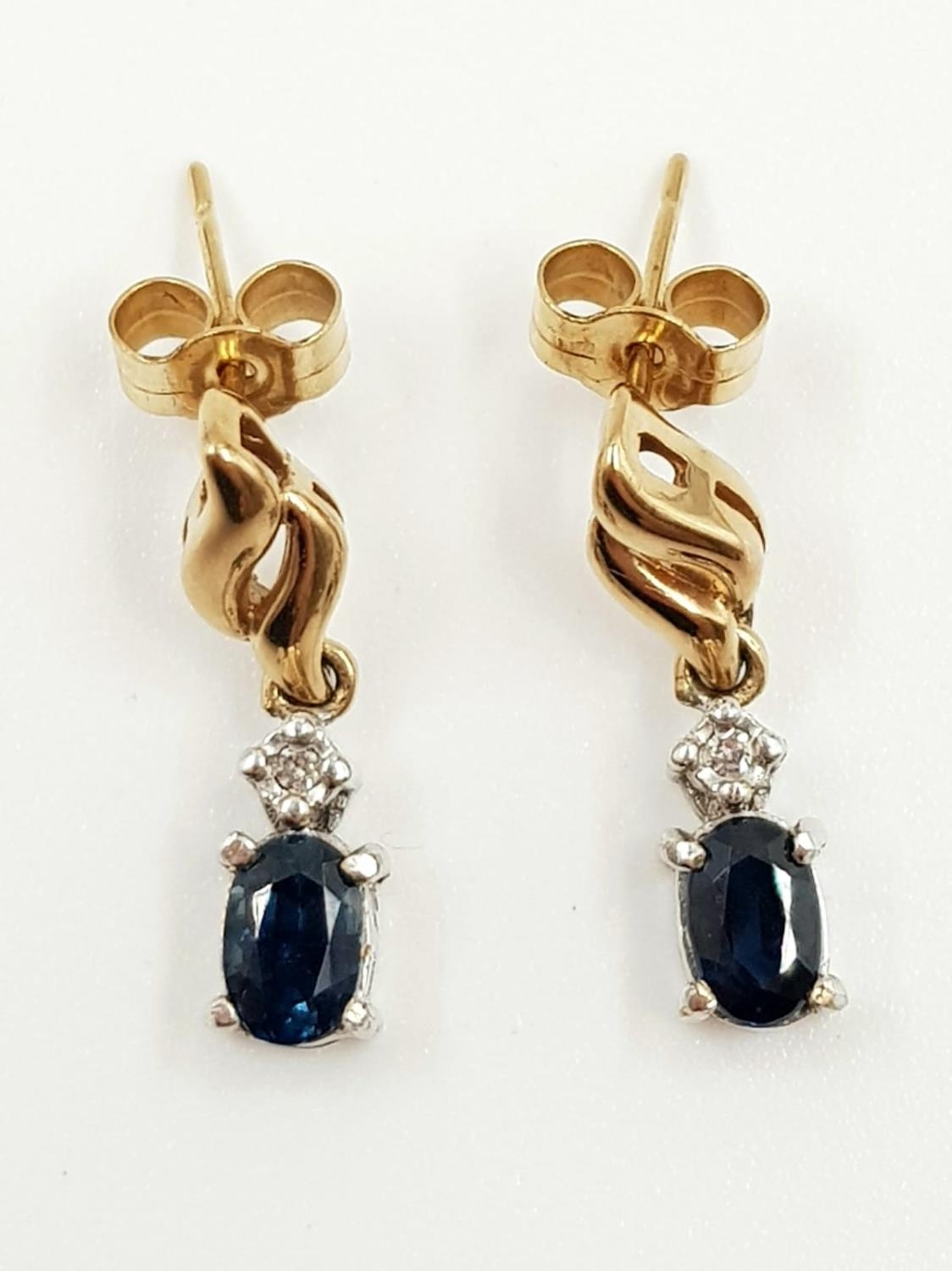 A pair of sapphire and diamond earrings in 9ct gold. 2.4g total weight. - Image 2 of 3