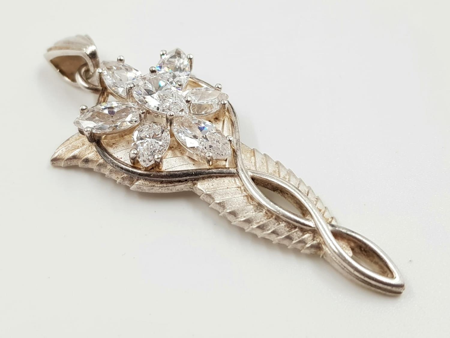 A silver and diamond-like pendant. 13.5g total weight and 5cm length.