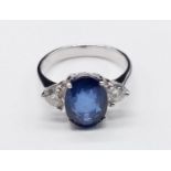 18ct White Gold RING set with one oval cut natural Sapphire and 2x round brilliant cut natural