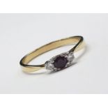 18ct yellow gold diamond and ruby 3 stone ring. Size S and weighs 2.66g.