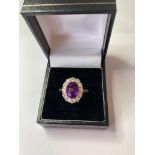18Ct Gold, Diamond and Amethyst RING. Has a large 2 carat faceted oval Amethyst to top with a 1.2