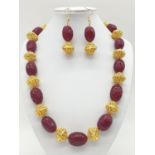 An impressive Indian necklace and earrings set with engraved ruby cabochons and large pierced and