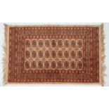 Small Chinese silk rug. 106x67cm with fringed ends.