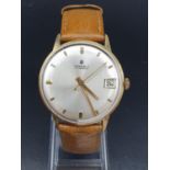 A vintage 14ct gold Junghans men's watch. Gold case with silver dial. Comes with original leather