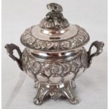 An Antique Silver Miniature Urn. Ornate decoration, twin handles and pedestal feet. 10cm high. 99g