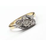 18ct yellow gold and platinum 3 stone twist ring size N1/2. 0.15ct and weighs 3.2g.