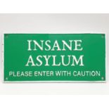 A cast iron sign reading INSANE ASYLUM. Dimensions: 27 x 13 cm.