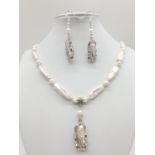 An unusual Biwa pearls and sterling silver necklace and earrings set in a presentation case.