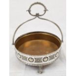 An Antique Silver Bon Bon Dish with Handle. Removable Brass Inlet. Floral design around circular