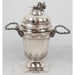 An Antique small Silver Urn. Silver Wire Handles, ribbed body and lid, finished with a wilting