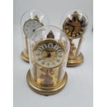 A Trio of Glass-Domed Eight-Day Clocks. 20cm