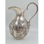 A LARGE SPANISH SILVER WATER JUG HAND FASHIONED CIRCA 1920. 474.4 gms and 27cms TALL