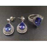 A 14CT WHITE GOLD MATCHING SET OF EARRINGS AND DRESS RING WITH LARGE PEAR SHAPED TANZANITE STONES