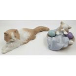 A Pair of Lladro Figures. A cat at rest and a Cat at play. 12 and 26cm length.