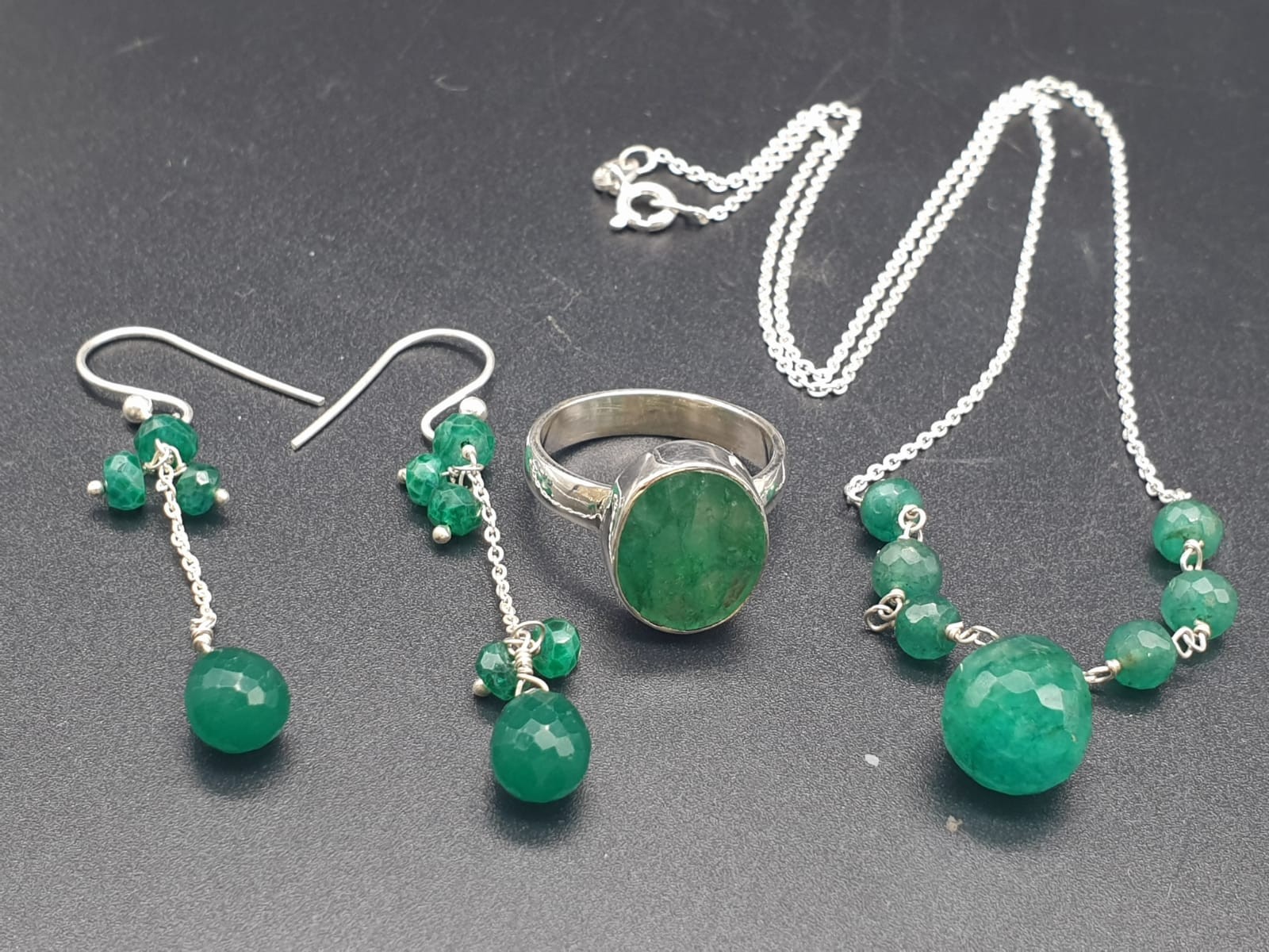 A collection of emerald drops necklace with matching earrings and emerald ring size O