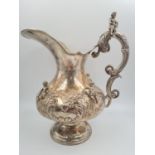 A LARGE SPANISH SILVER ETRUSCAN SHAPED WATER JUG, HAND DECORATED WITH CHERUBS AND FLORA. 1.2kg and