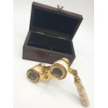 1920's Mother of Pearl & Brass opera glasses with folding handle, in wooden box. 13x7cm.