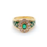 AN 18CT YELLOW GOLD RING WITH BRILLIANT DIAMONDS AND EMERALDS.6.6gms SIZE N